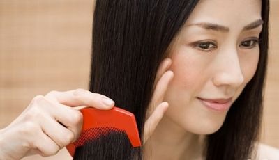 Woman combing hair